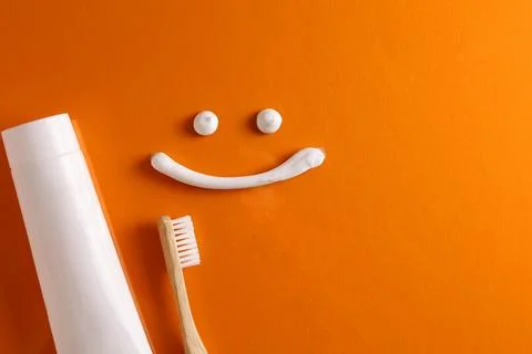 Toothpaste and toothbrush on a colored background. Dental care, oral health. Stock Photos