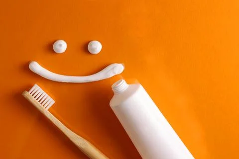 Toothpaste and toothbrush on a colored background. Dental care, oral health. Stock Photos