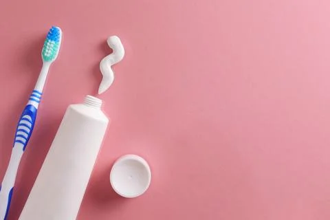 Toothpaste and toothbrush on a colored background. Dental care, oral health. Stock Photos