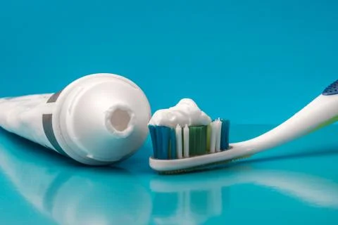 Toothpaste and toothbrush with reflection Stock Photos