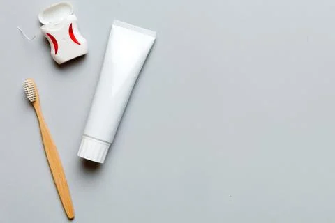 Toothpaste and toothbrush top view with copy space on colored background. F.. Stock Photos