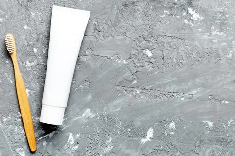 Toothpaste and toothbrush top view with copy space on colored background. Fla Stock Photos