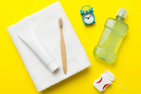 Toothpaste and toothbrush top view with copy space on colored background. Fla Stock Photos