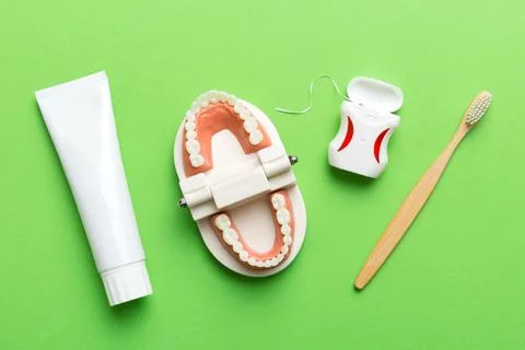 Toothpaste and toothbrush top view with copy space on colored background. Fla Stock Photos