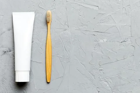 Toothpaste and toothbrush top view with copy space on colored background. Fla Stock Photos