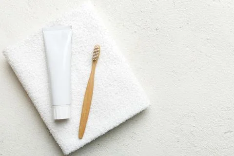 Toothpaste and toothbrush top view with copy space on colored background. Fla Stock Photos