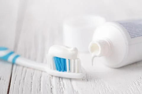 Toothpaste and tube on white table Stock Photos
