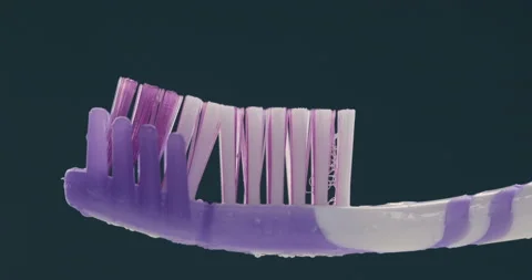 Toothpaste is applied to a toothbrush. Close up shot Stock Footage 131343804