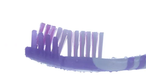 Toothpaste is applied to a toothbrush. Close up shot Stock Footage 131344339
