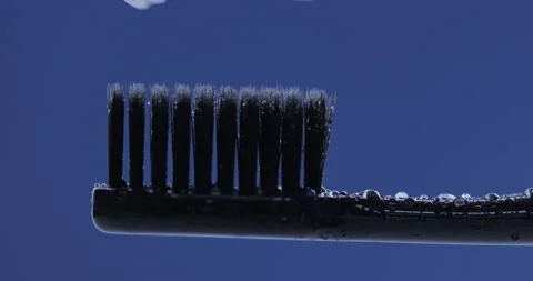 Toothpaste is applied to a toothbrush. Close up shot Stock Footage 131344425