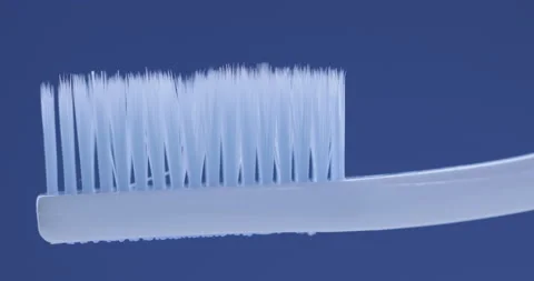 Toothpaste is applied to a toothbrush. Close up shot Stock Footage 131344569