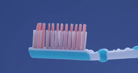 Toothpaste is applied to a toothbrush. Close up shot Video stock 131344693