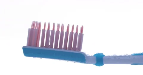 Toothpaste is applied to a toothbrush. Close up shot Stock Footage 131344746