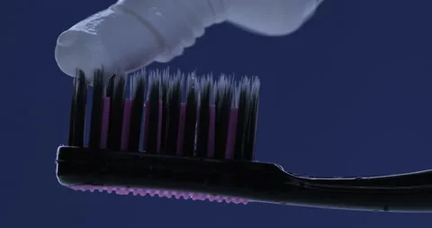 Toothpaste is applied to a toothbrush. Close up shot Stock Footage 138638200