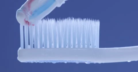 Toothpaste is applied to a toothbrush. Close up shot Stock Footage 139093268