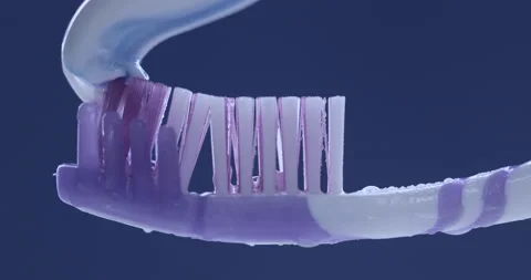 Toothpaste is applied to a toothbrush. Close up shot Video stock 139763531