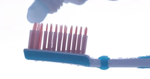 Toothpaste is applied to a toothbrush. Close up shot Stock Footage 139763628