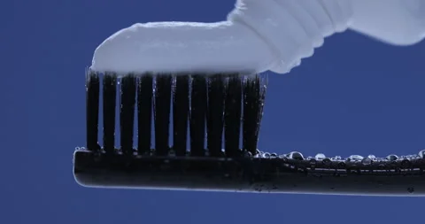 Toothpaste is applied to a toothbrush. Close up shot Stock Footage 140688010