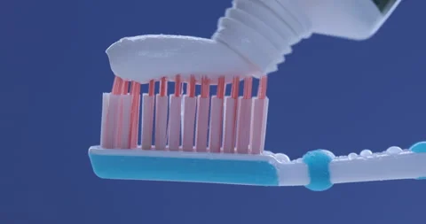 Toothpaste is applied to a toothbrush. Close up shot Stock-Footage 140688162