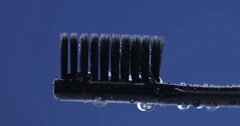 Toothpaste is applied to a toothbrush. Close up shot Stock Footage 141342023