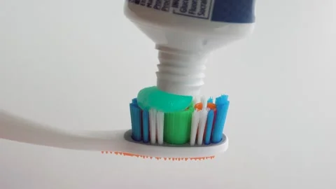 Toothpaste being applied on a toothbrush. Close up Stock Footage 252568427