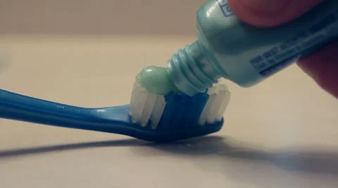Toothpaste Being Put on Toothbrush - Close Up Video stock 34480623