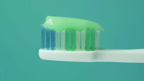 Toothpaste being squeezed on to a toothbrush Stock Footage 72359691