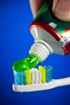 Toothpaste being squeezed onto a toothbrush 스톡 사진