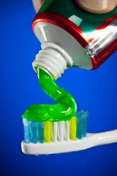 Toothpaste being squeezed onto a toothbrush 스톡 사진