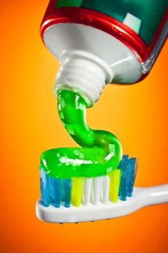 Toothpaste being squeezed onto a toothbrush 스톡 사진