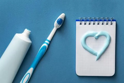 Toothpaste with brush and notebook with heart Stock Photos