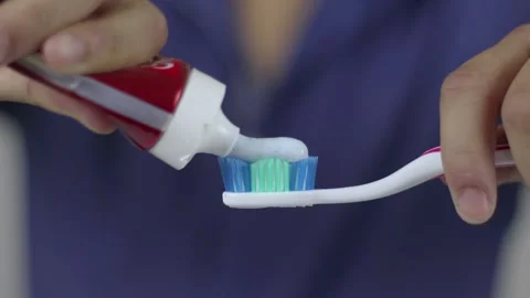 Toothpaste Dropping A Toothbrush Stock Footage 233859034