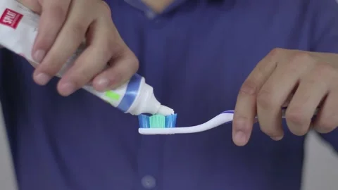 Toothpaste Dropping A Toothbrush Stock Footage 233859142