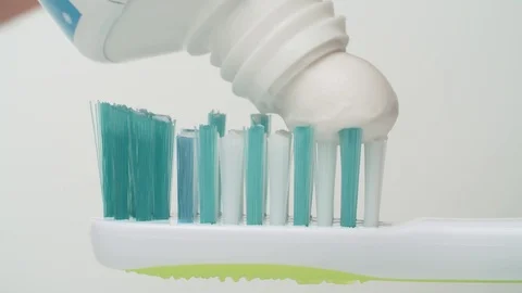 Toothpaste extruded onto a toothbrush Stock Footage 124205737