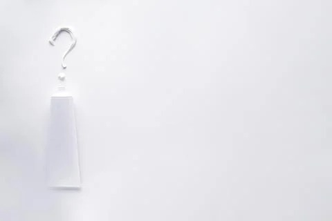 Toothpaste in the form of a question mark, on a white background with prostra Foto stock