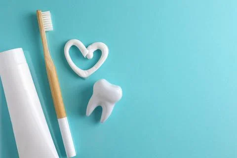 Toothpaste heart on a colored background. Dental care, oral health. Stock Photos