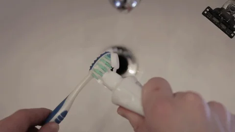 Toothpaste layered on a toothbrush Stock Footage 104404677