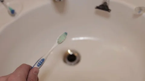 Toothpaste is layered onto a toothbrush. Stock Footage 104404701