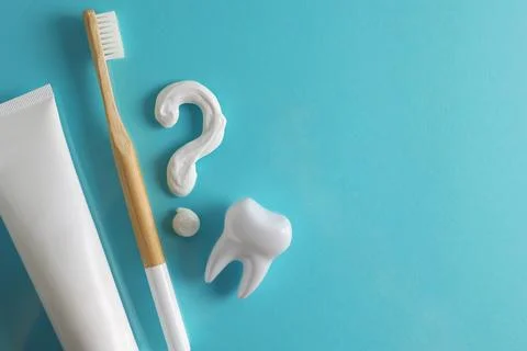 Toothpaste question mark on a colored background. Dental care, oral health. Stock Photos