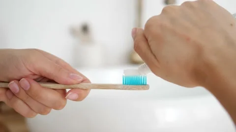 The toothpaste is squeezed onto the toothbrush. Stock Footage 218348681