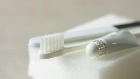 Toothpaste, toothbrush and various disposable items Stock Photos