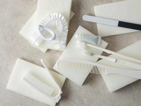 Toothpaste, toothbrush and various disposable items Stock Photos