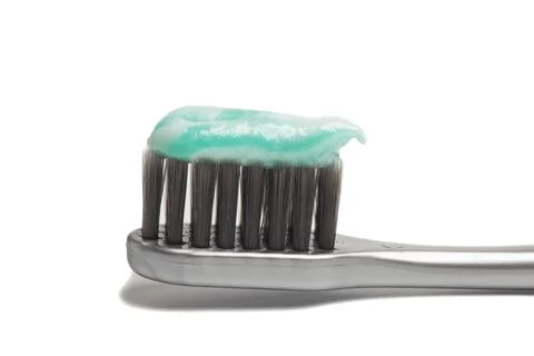 Toothpaste on toothbrush isolated on white background Stock Photos