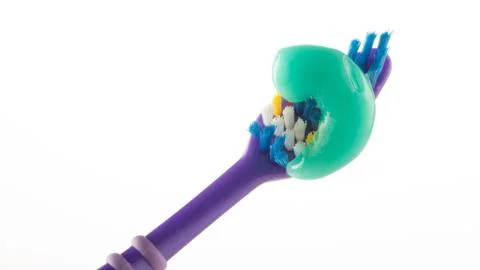 Toothpaste on a toothbrush on a white background Stock Photos