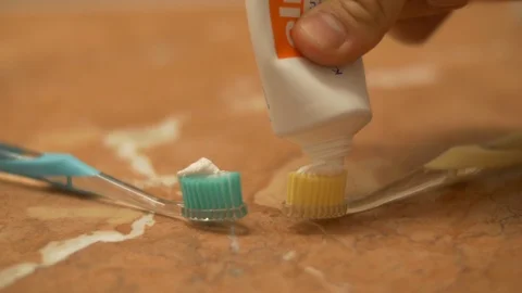 Toothpaste onto toothbrushes Stock-Footage 94832927