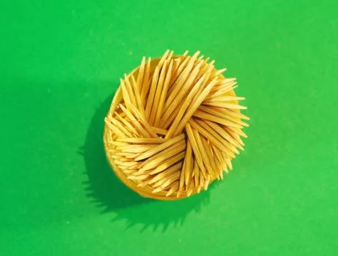Toothpicks with holder green screen in background closeup photo. top view. Stock Photos