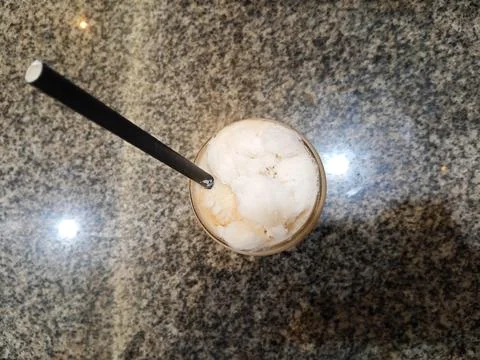 Top above overhead close up view photo of cold milk tea over ceramic table Stock Photos