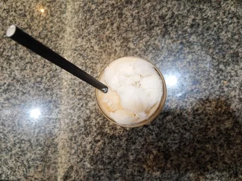 Top above overhead close up view photo of cold milk tea over ceramic table Stock Photos