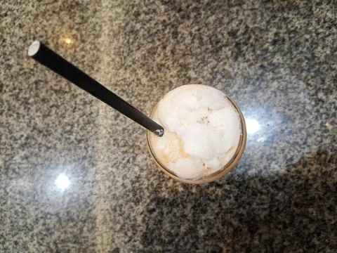 Top above overhead close up view photo of cold milk tea over ceramic table Stock Photos