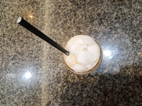 Top above overhead close up view photo of cold milk tea over ceramic table Stock Photos